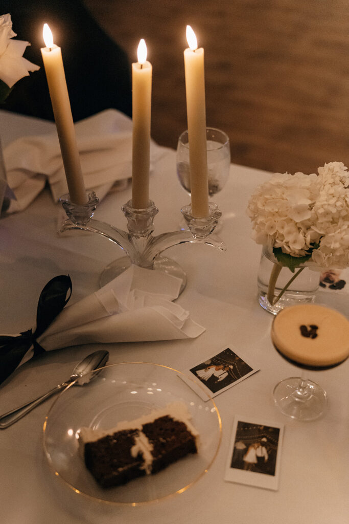 A candlelit reception table with soft florals and place settings creates a refined, intimate atmosphere typical of elegant New England wedding venues.