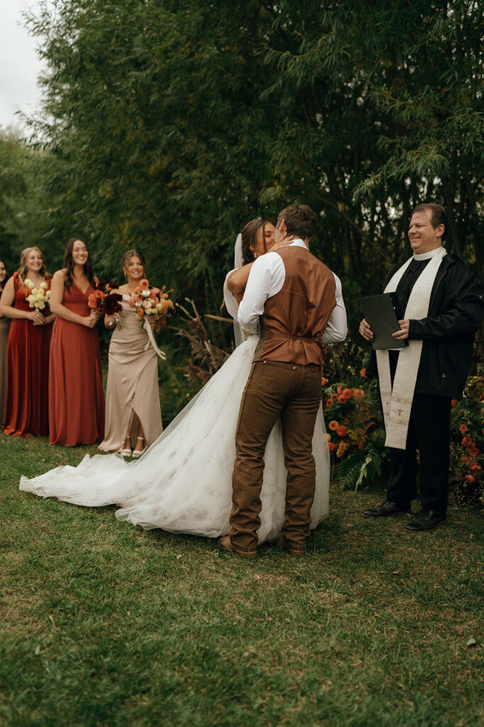 Bride and groom exchanging vows during an intimate outdoor fall New England wedding ceremony